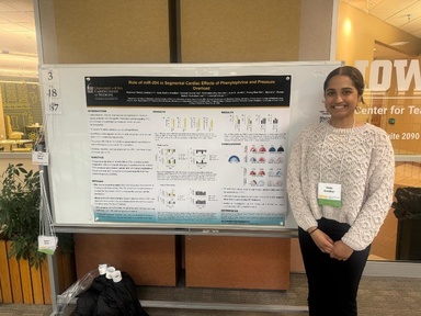 Photo of Veda Amalkar and her poster